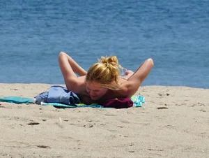 Sexy ass blonde milf on the beach in a thong with cameltoe and bending over