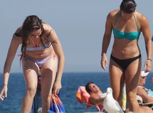 2 cute friends in bikinis on the beach