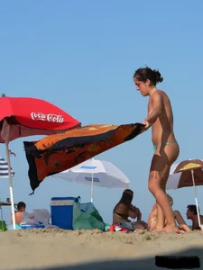 2 topless thonged sexy friends on the beach with great bodies