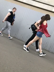 Very hot candid girl in denim shorts walking down the train platform
