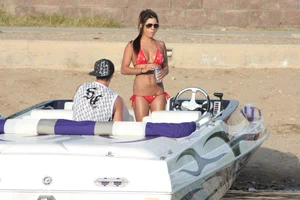 Brunette on a boat in red thong bikini with a tight little ass