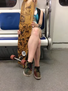 Girl with Cute Legs and a Skateboard in a Subway Train Candid Photo