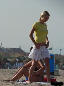 Blonde on the beach topless with big boobs and in a black thong