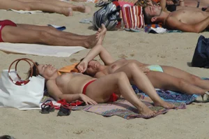 Topless girls on a beach in Barcelona