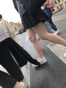 Closeups of a candid girl's legs on a crosswalk