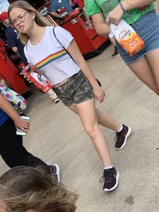 Bunch of girls in various outfits at a Cardinals baseball game