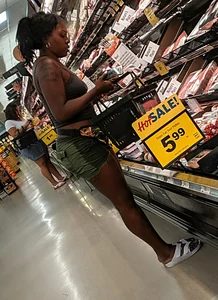 Ebony chick grocery shopping in green shorts