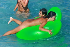 FKK Nudists playing in the water with floater