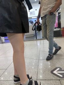 Pale Legs of a Slim Teen at a Mall Gallery
