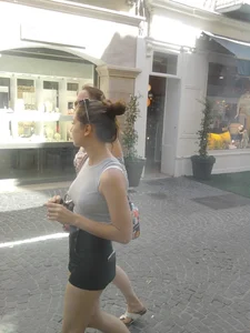 Cute babe in short black denim shorts and tank top