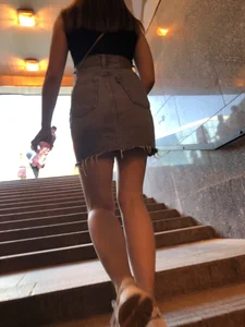 Hot chick wearing a fringed skirt walking up the stairs