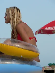Sexy mom and daughter in red thongs at the beach
