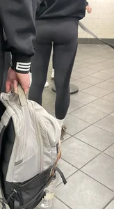 Tight ass sports team in line at airport