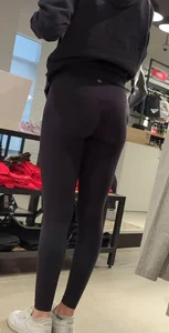 Skinny sports store employee in yoga pants