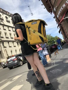 Amazing cute candid food delivery girl with lots of tattoos crossing the street
