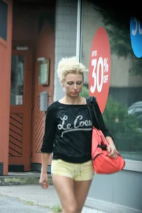 Blonde looking sexy walking in short yellow shorts
