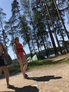 Young Girl in a One-Piece Swimsuit Walking on a Forest Road Photo Gallery