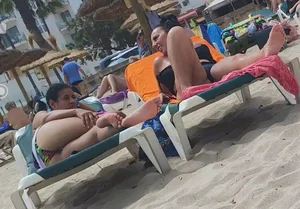 Milfs and girls resting at the beach in sexy bikinis
