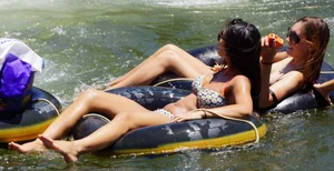 Sexy party girls in bikinis on a lake