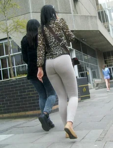 Brunette lady with a nice ass in light grey leggings walking