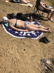 Girl in Swimsuit Lying on the Beach on Her Stomach