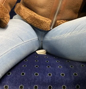 Crotch closeup creepshot of a candid public bus girl wearing tight blue jeans