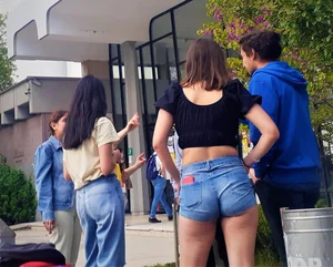Chunky girl wearing a top and denim shorts