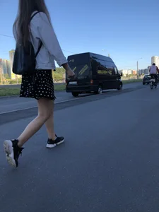 Extremely Cute Girl in a Skirt With a Backpack Passing By on the Street Gallery