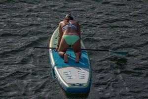Busty chick in bikini bends over