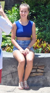 Beautiful girl in a blue top and denim shorts
