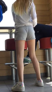 Gorgeous teen in shorts in a cafe