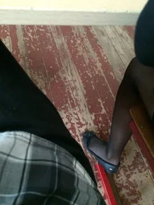College Teen’s Legs in Black Pantyhose And Feet in Flats Closeup Photos
