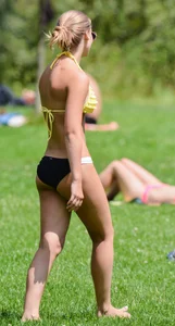 Sexy blonde girl in the park playing volleyball in her skimpy bikini