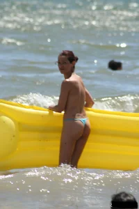 Blue thong lady in the water with a float