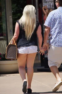 Thick blonde with big boobs in short white shorts
