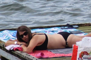 Thick babe with big boobs in a black bikini