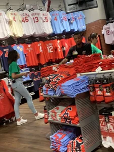 Bunch of girls in various outfits at a Cardinals baseball game