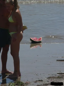 Sexy blonde on the beach in a yellow thong bikini