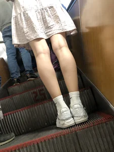 Cute Girl in a Dress with Thin Hot Legs Standing on the Subway Escalator Closeup Creepshots Gallery