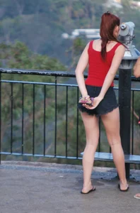Redhead beauty in short shorts showing some cheeks and panties