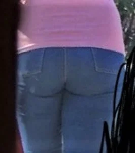 Girl wearing tight blue jeans in the backyard creepshots