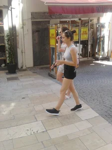 Cute babe in short black denim shorts and tank top