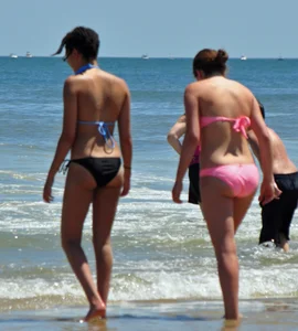 Two teen friends in bikinis at the beach