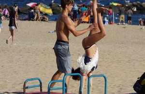 Beach teen in semi thong bikini under see through dress on the beach