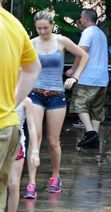 Cute blonde in denim shorts and a wet top