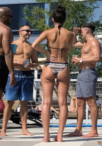 Fit brunette spotted at the pool in a cheeky bikini