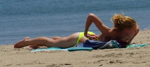 Sexy ass blonde milf on the beach in a thong with cameltoe and bending over