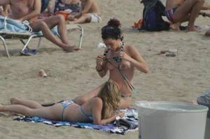 Topless girls on a beach in Barcelona