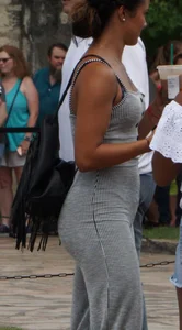 Latina with a great ass in a grey one piece outfit