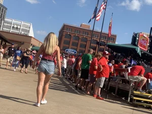 Bunch of girls in various outfits at a Cardinals baseball game